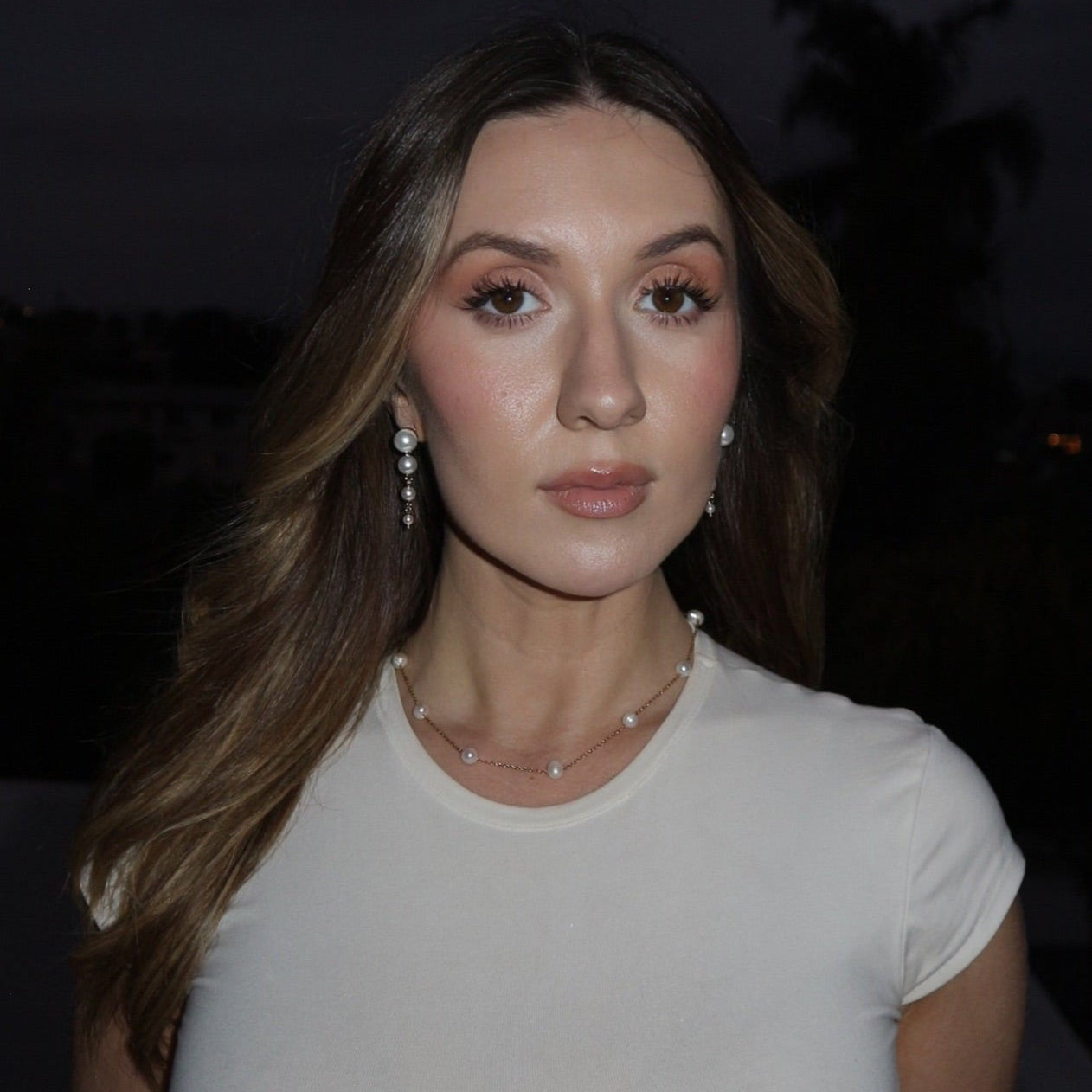 Woman wearing a white top with a blurred background