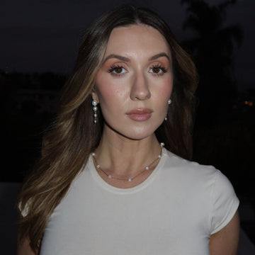 Woman wearing a white top with a blurred background
