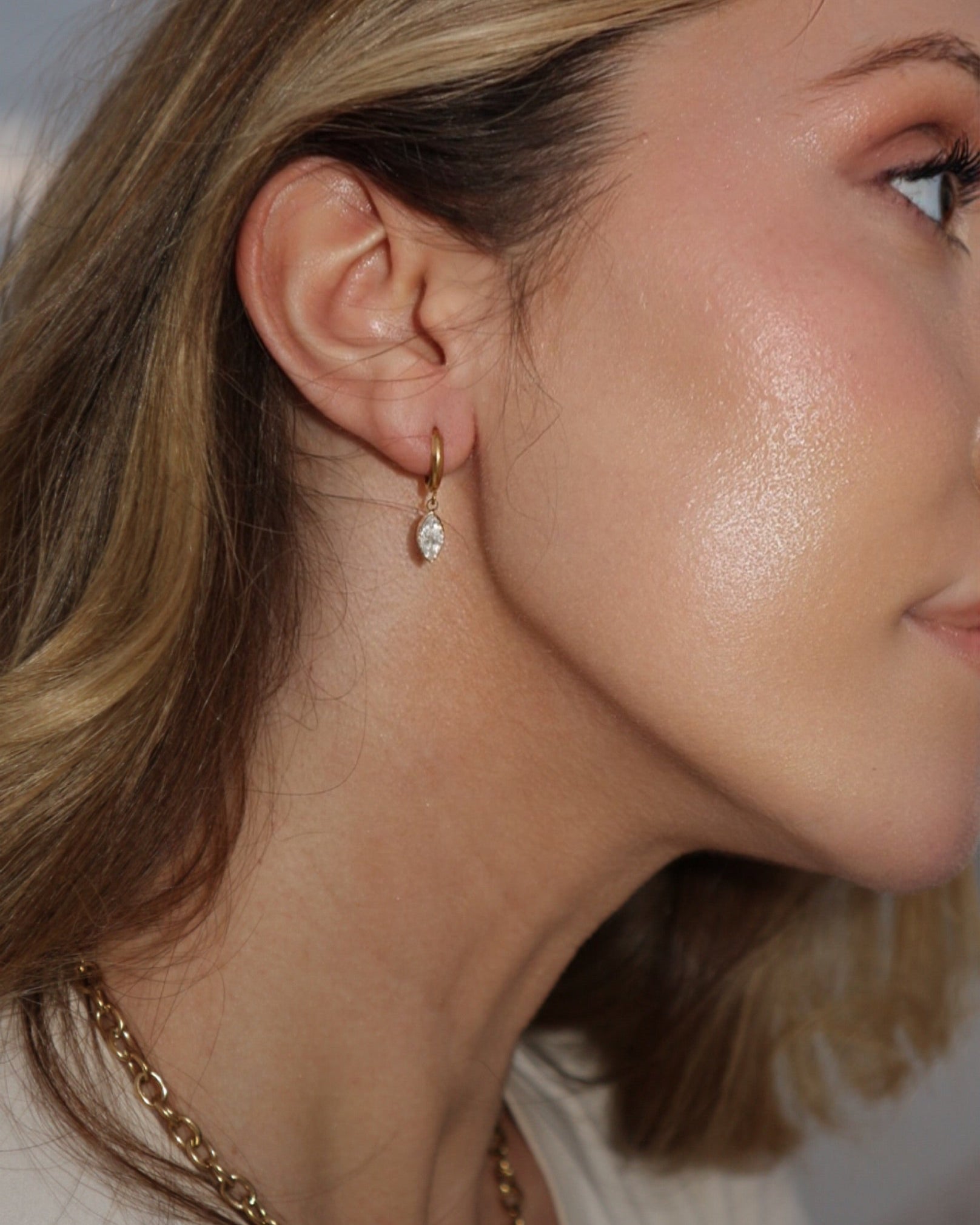 close up up woman with gold earrings 